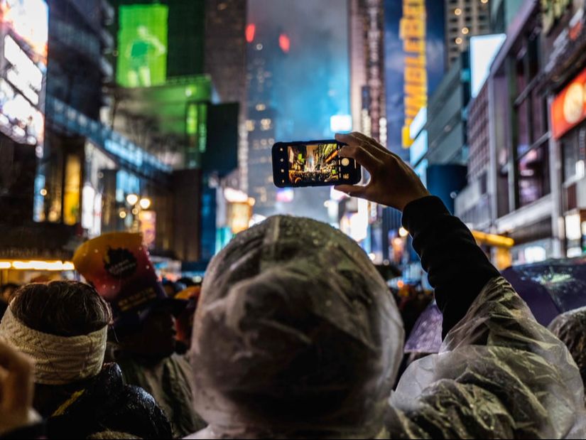 An image of a person taking a photo with a smartphone in Times Square. Image used with permission from When Wire Was King.