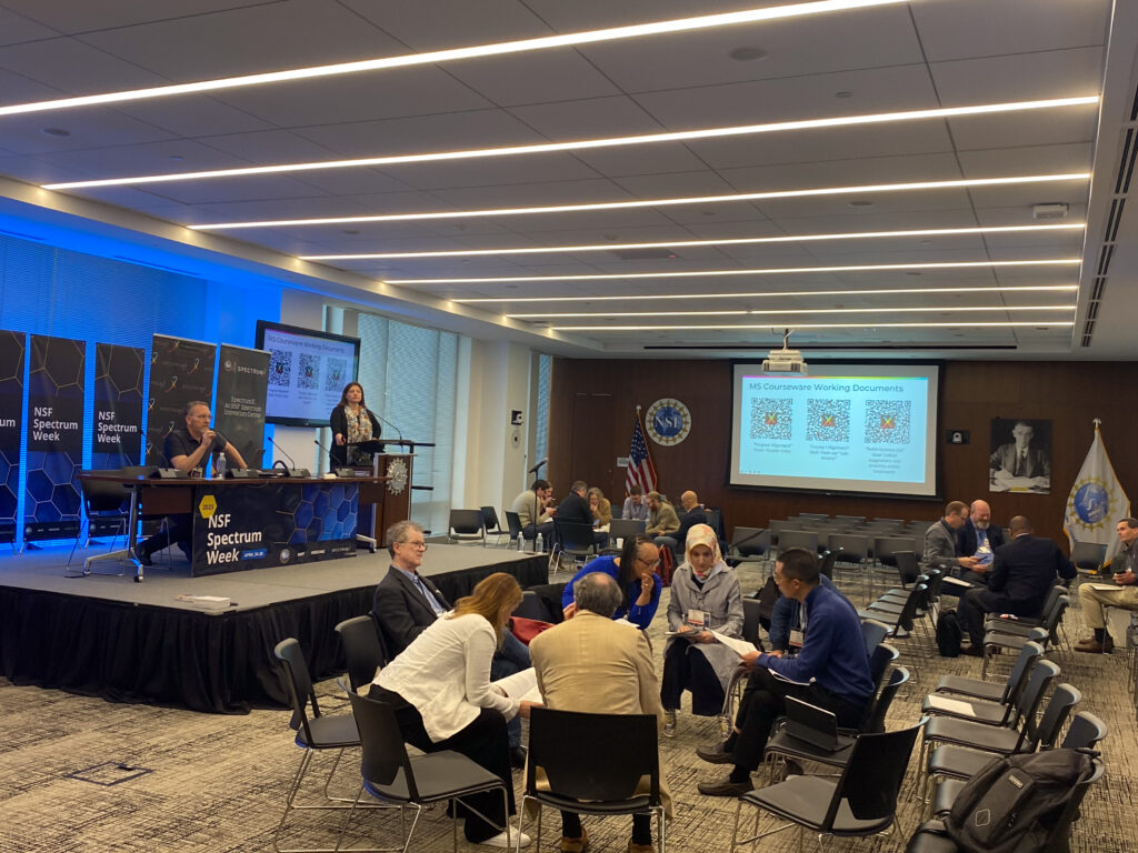 During the Education and Workforce Development session of NSF Spectrum Week's SpectrumX Center Meeting, participants divided into discussion groups in the main meeting room to work on potential solutions to challenges.