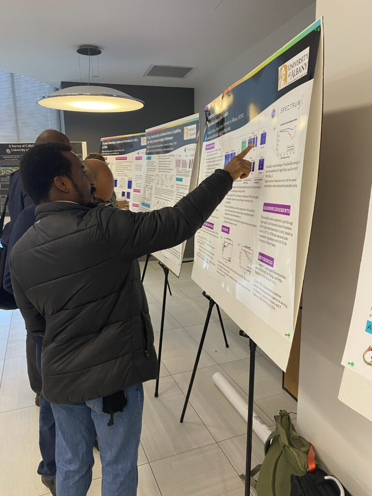 A student discusses his research during a poster session at NSF Spectrum Week 2023. 