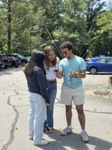 Three students work on an hands-on RFI activity at the NRAO during the 2025 SpectrumX Summer School